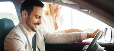 man smiling in driver's seat